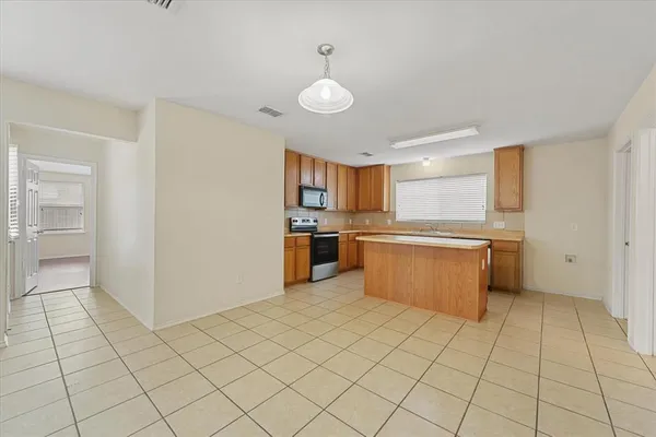 a big room with wooden floor and windows