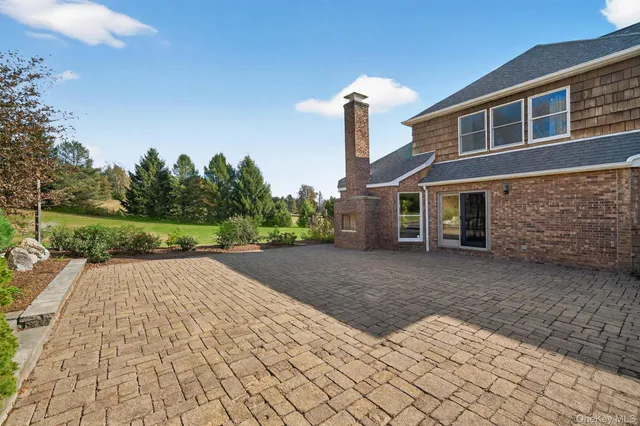 a front view of a house with a yard and trees