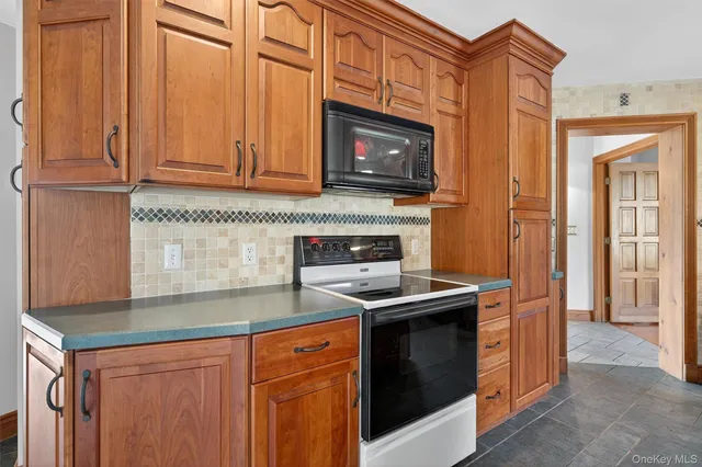 a kitchen with stainless steel appliances granite countertop a stove and a microwave