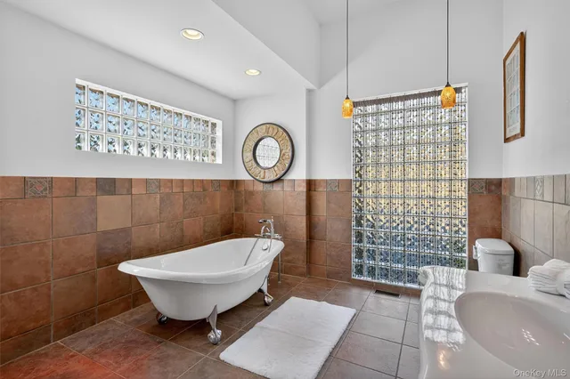 a bathroom with a toilet a sink and a shower