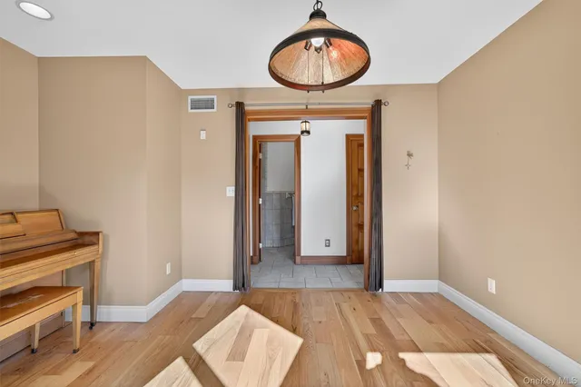a view of a room with wooden floor