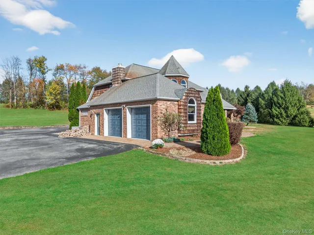 an aerial view of a house with a yard basket ball court and outdoor seating