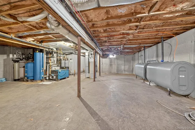 a view of water heater room with refrigerator