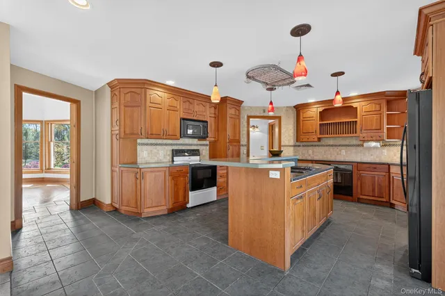 a kitchen with stainless steel appliances granite countertop a stove and a sink