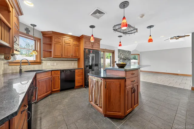 a kitchen view with stainless steel appliances granite countertop a stove and cabinets