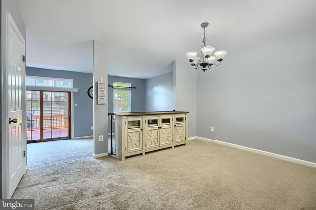 a view of kitchen with a sink and chandelier