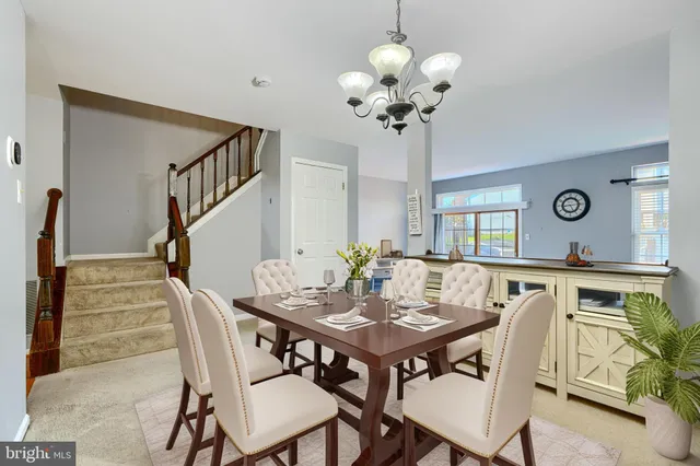 a view of a dining room with furniture and chandelier
