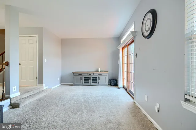 a living room with furniture a large window and a flat screen tv