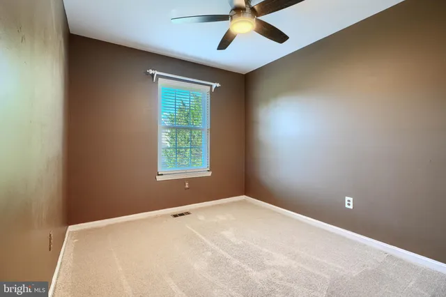 an empty room with ceiling fan