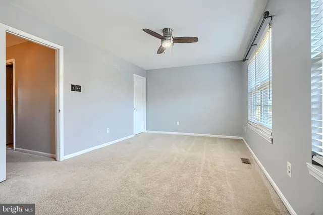 an empty room with windows and closet