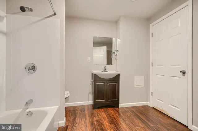a bathroom with a sink a toilet and a bathtub