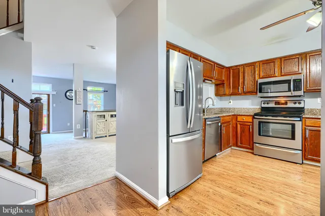 a kitchen with stainless steel appliances granite countertop a refrigerator stove and oven