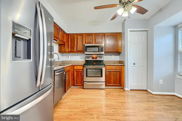 a kitchen with stainless steel appliances a stove a refrigerator and a microwave