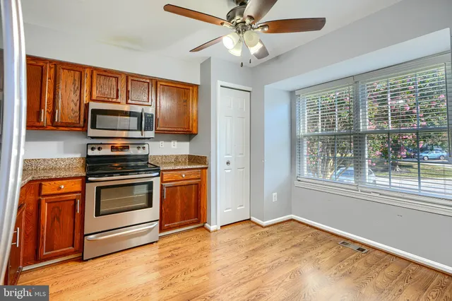 a kitchen with stainless steel appliances granite countertop a stove and a microwave