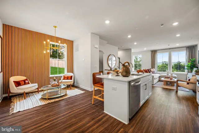 a open kitchen with stainless steel appliances granite countertop a stove and a wooden floors