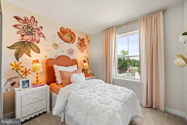 a bed sitting in a bedroom next to a window