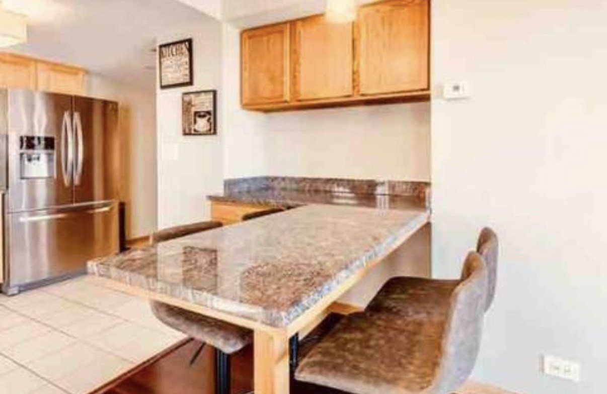 10620 Central Avenue, Unit 2A Chicago Ridge, IL 60415 - Photo 8 of 16 a kitchen with granite countertop sink and refrigerator