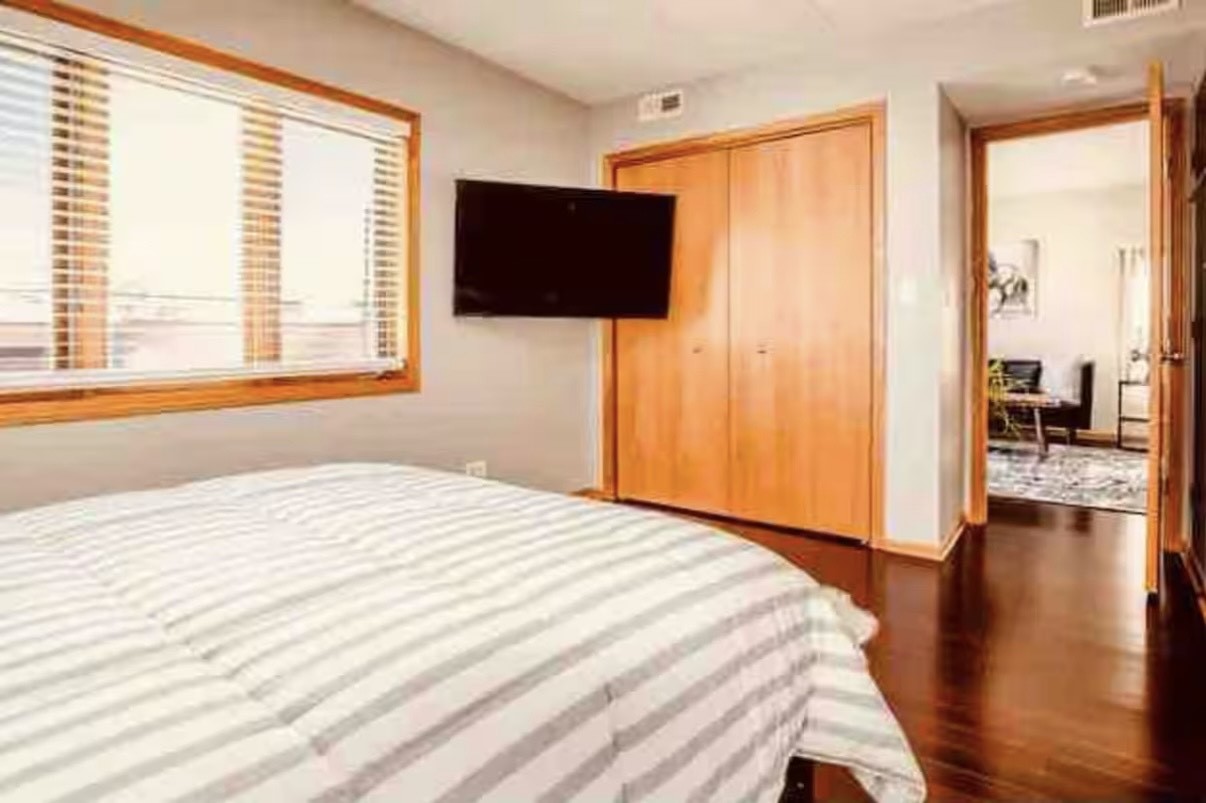 10620 Central Avenue, Unit 2A Chicago Ridge, IL 60415 - Photo 9 of 16 a bedroom with a bed and wooden floor