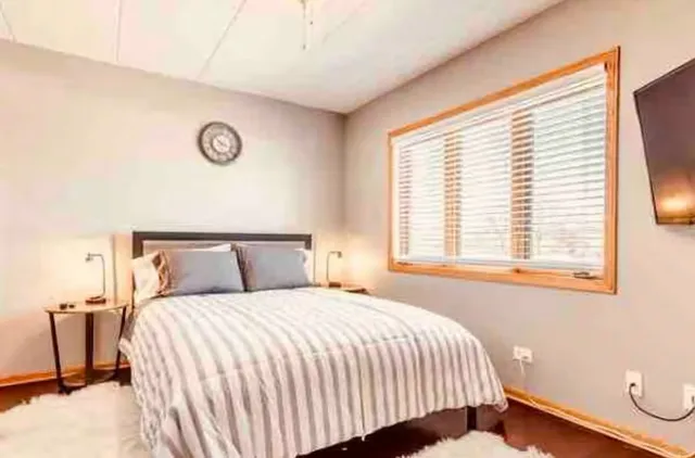 a bedroom with a bed and a window