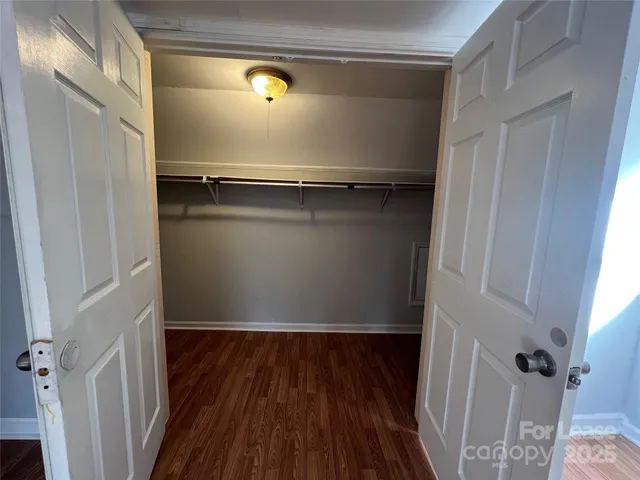 a view of closet with wooden floor