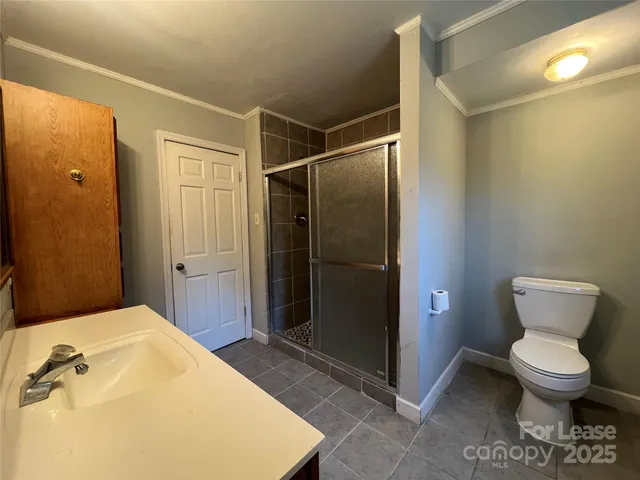 a bathroom with a toilet and a shower