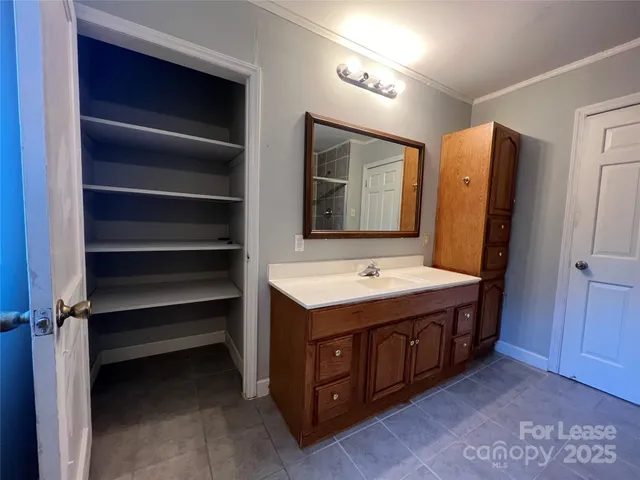 a bathroom with a sink and mirror