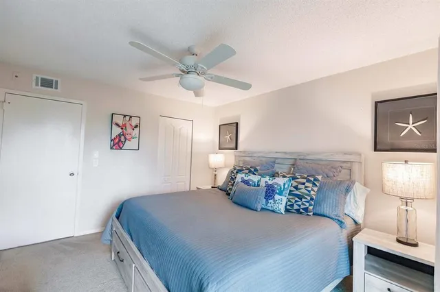 a bedroom with a bed and a lamp