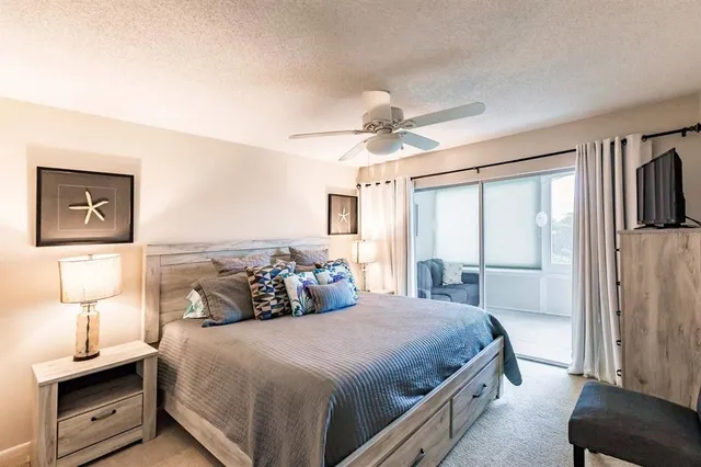 a bedroom with a bed and a lamp on a dresser