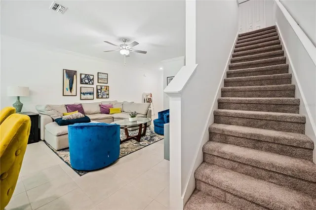 a living room with furniture and a stairs
