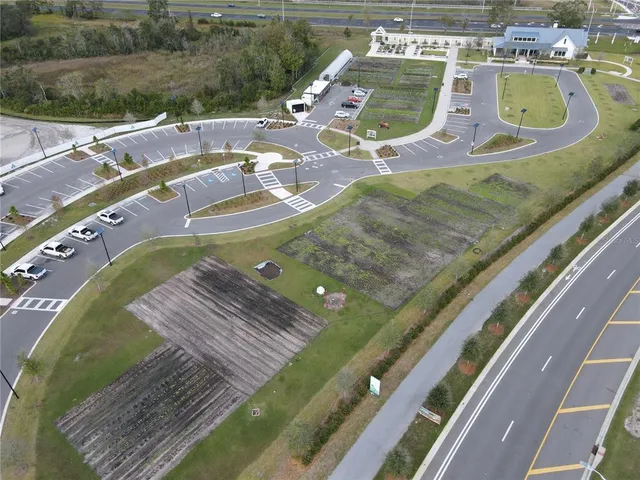 a view of a swimming pool with a yard from a balcony