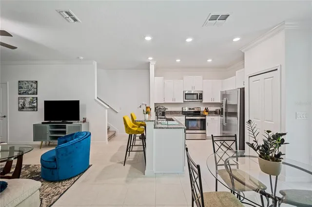 a kitchen with a refrigerator and a dining table
