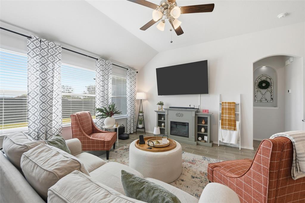 725 Sandy Chip Trail Fort Worth, TX 76108 - Photo 16 of 30 a living room with furniture a fireplace and a flat screen tv