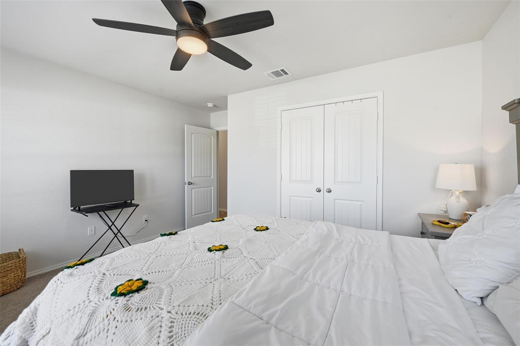 725 Sandy Chip Trail Fort Worth, TX 76108 - Photo 5 of 30 a bedroom with a bed and a chandelier