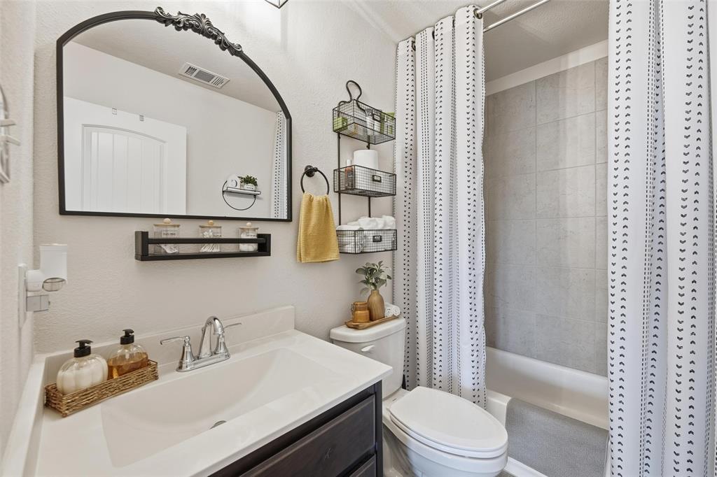725 Sandy Chip Trail Fort Worth, TX 76108 - Photo 6 of 30 a bathroom with a sink a toilet and shower curtain