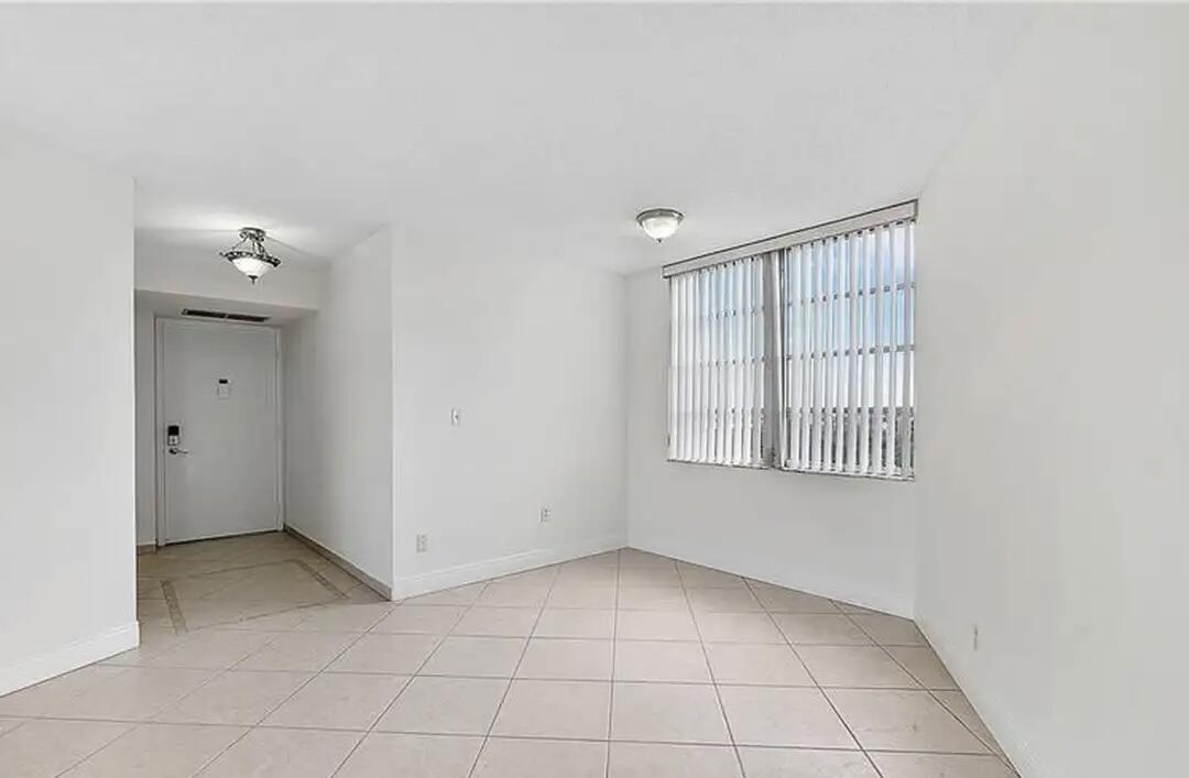 6921 Environ Boulevard, Unit 6S Lauderhill, FL 33319 - Photo 3 of 10 a view of an empty room with a window