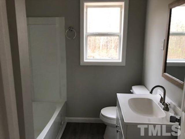 7646 Helena Moriah Road Rougemont, NC 27572 - Photo 8 of 37 a bathroom with a sink toilet and a mirror
