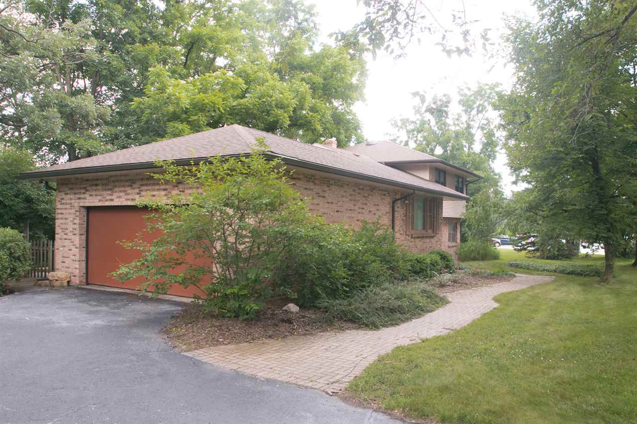 2703 North Alpine Road Rockford, IL 61114 - Photo 2 of 21 a backyard of a house with plants and trees
