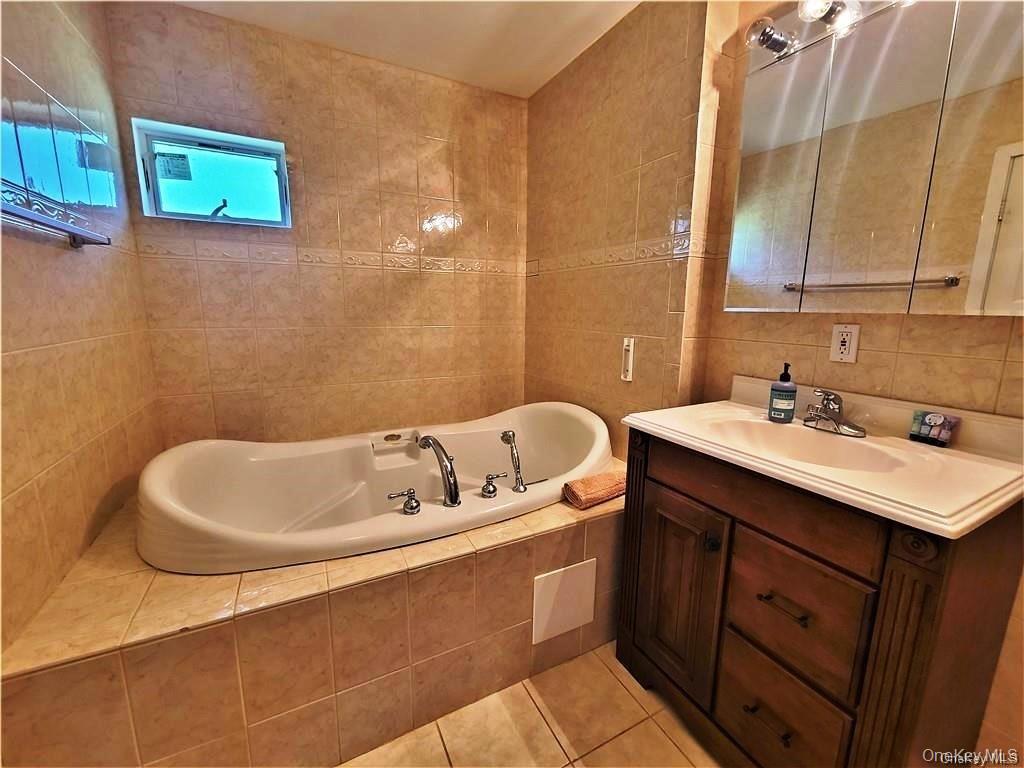 3437 State Rte 55 White Lake, NY 12786 - Photo 35 of 49 a bathroom with a sink and a bathtub