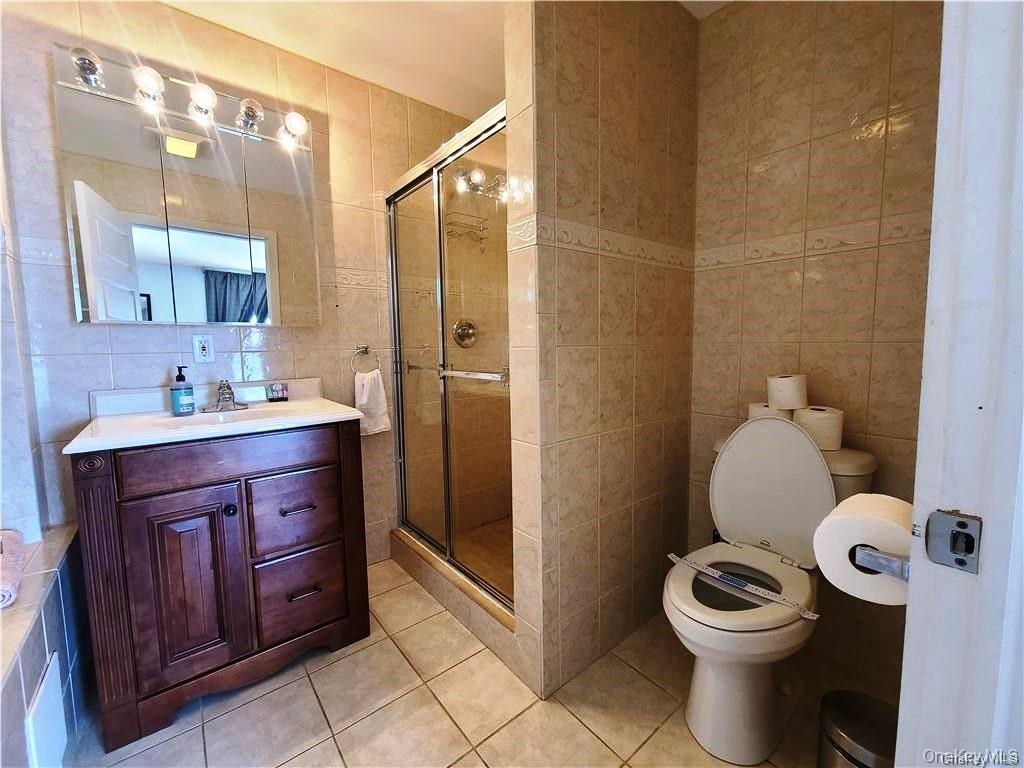3437 State Rte 55 White Lake, NY 12786 - Photo 36 of 49 a bathroom with a granite countertop toilet sink and mirror