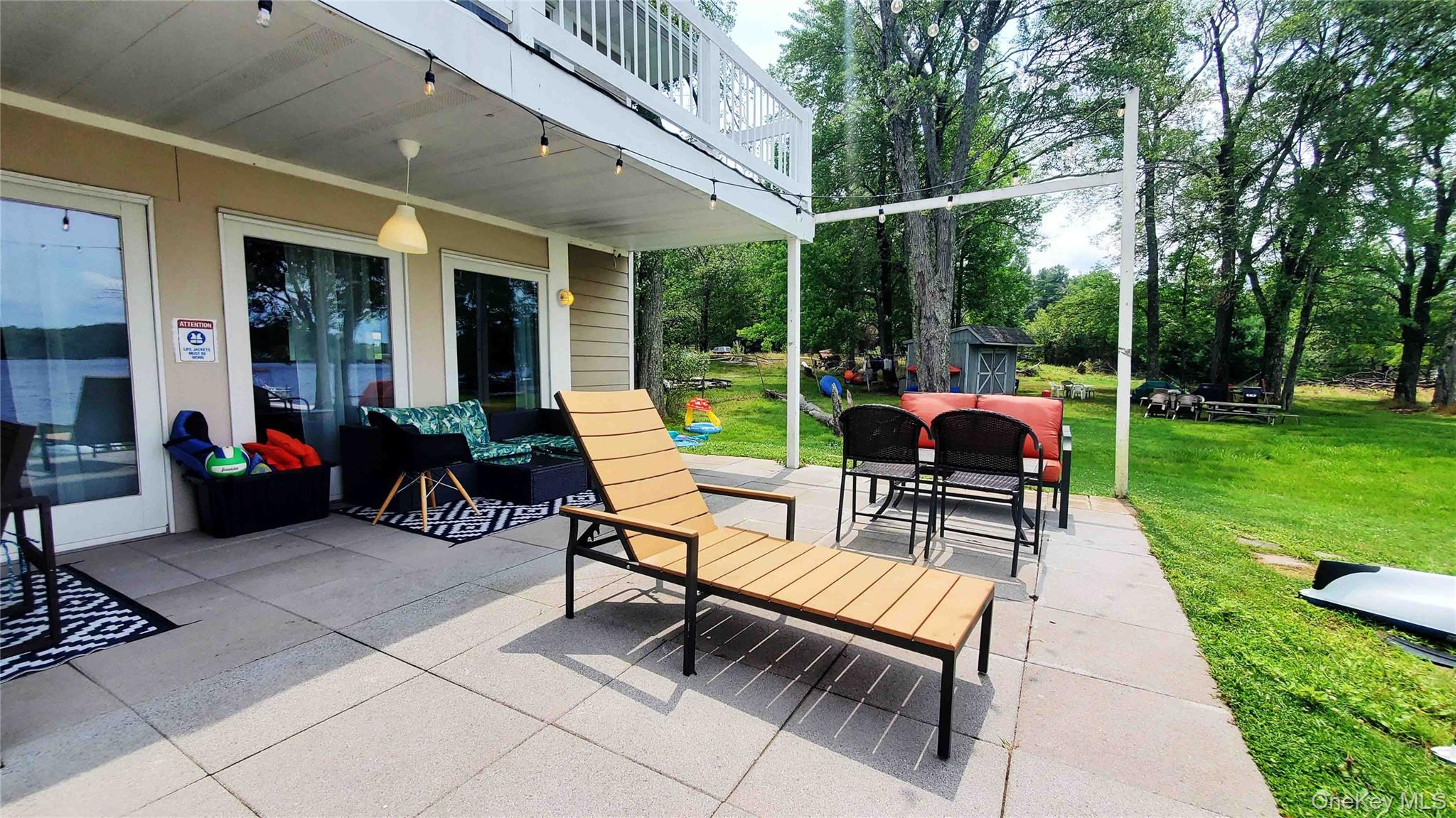3437 State Rte 55 White Lake, NY 12786 - Photo 42 of 49 a view of a patio with a dining table and chairs with wooden fence