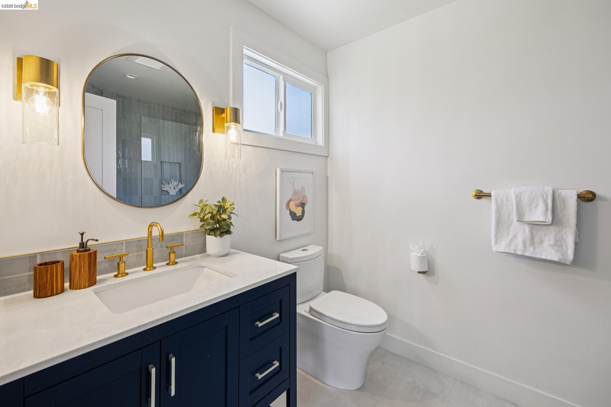 11 Belinda Court San Ramon, CA 94583 - Photo 16 of 33 Bathroom with a dark blue vanity, white countertop, and gold-finish fixtures