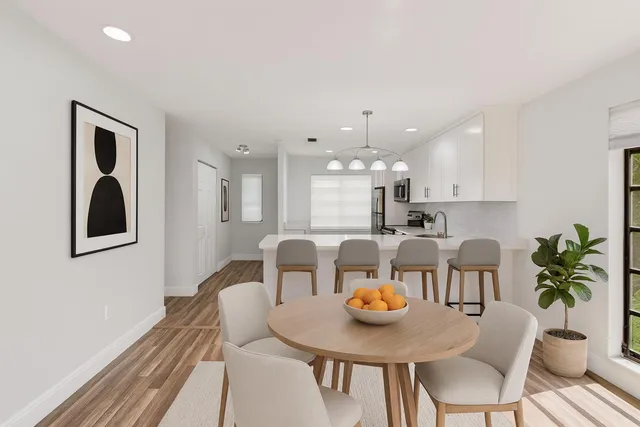 a kitchen with stainless steel appliances granite countertop a refrigerator sink and stove