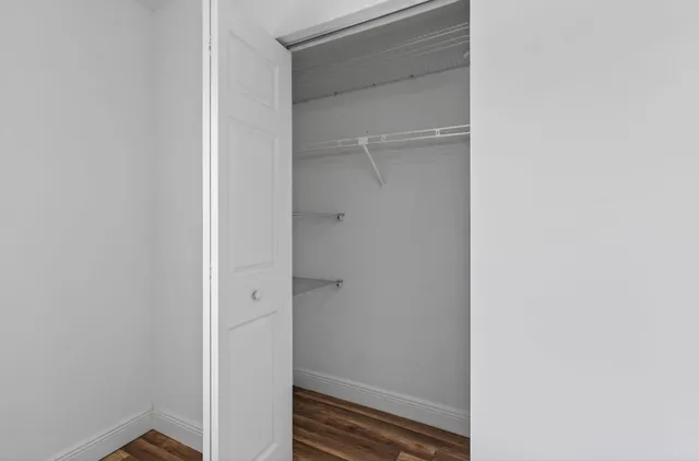 an aerial view of a house with garden space and a patio