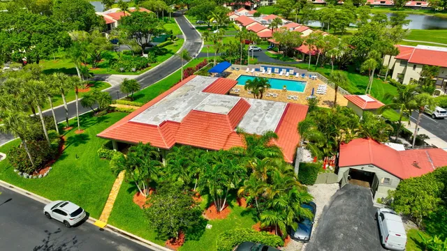 a view of a house with a big yard and a palm tree