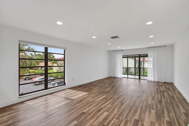 a view of kitchen with wooden floor and electronic appliances