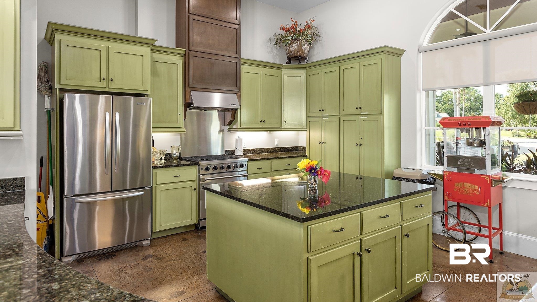 12489 Gateway Drive Elberta, AL 36530 - Photo 19 of 55 Kitchen with stainless steel appliances, green cabinetry, and wall chimney range hood