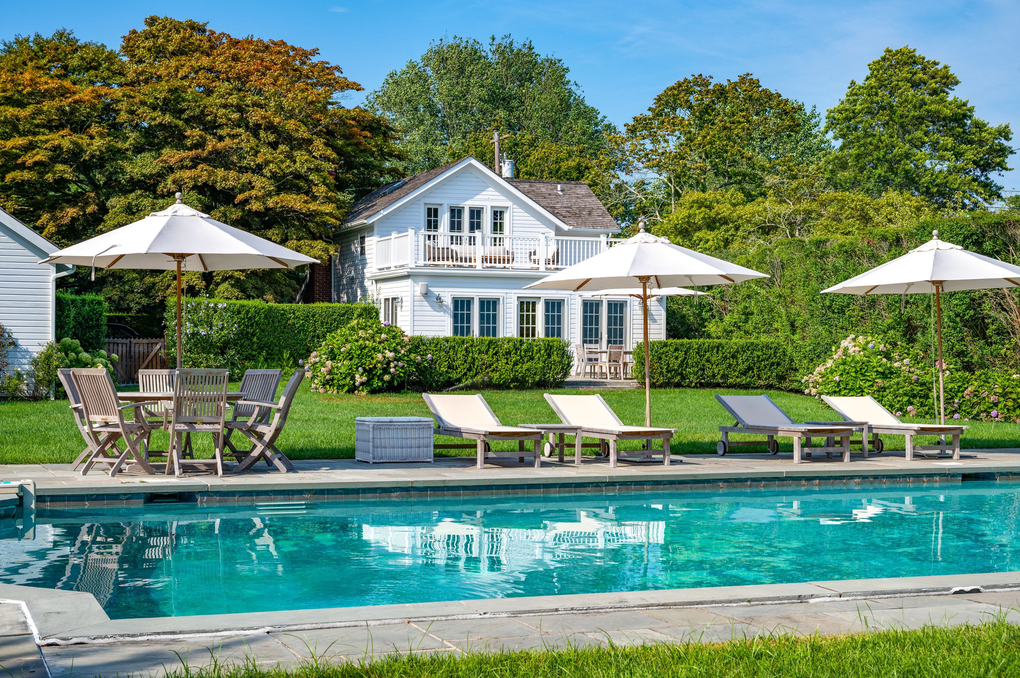 Undisclosed Address Southampton, NY 11968 - Photo 1 of 19 a front view of a house with a yard