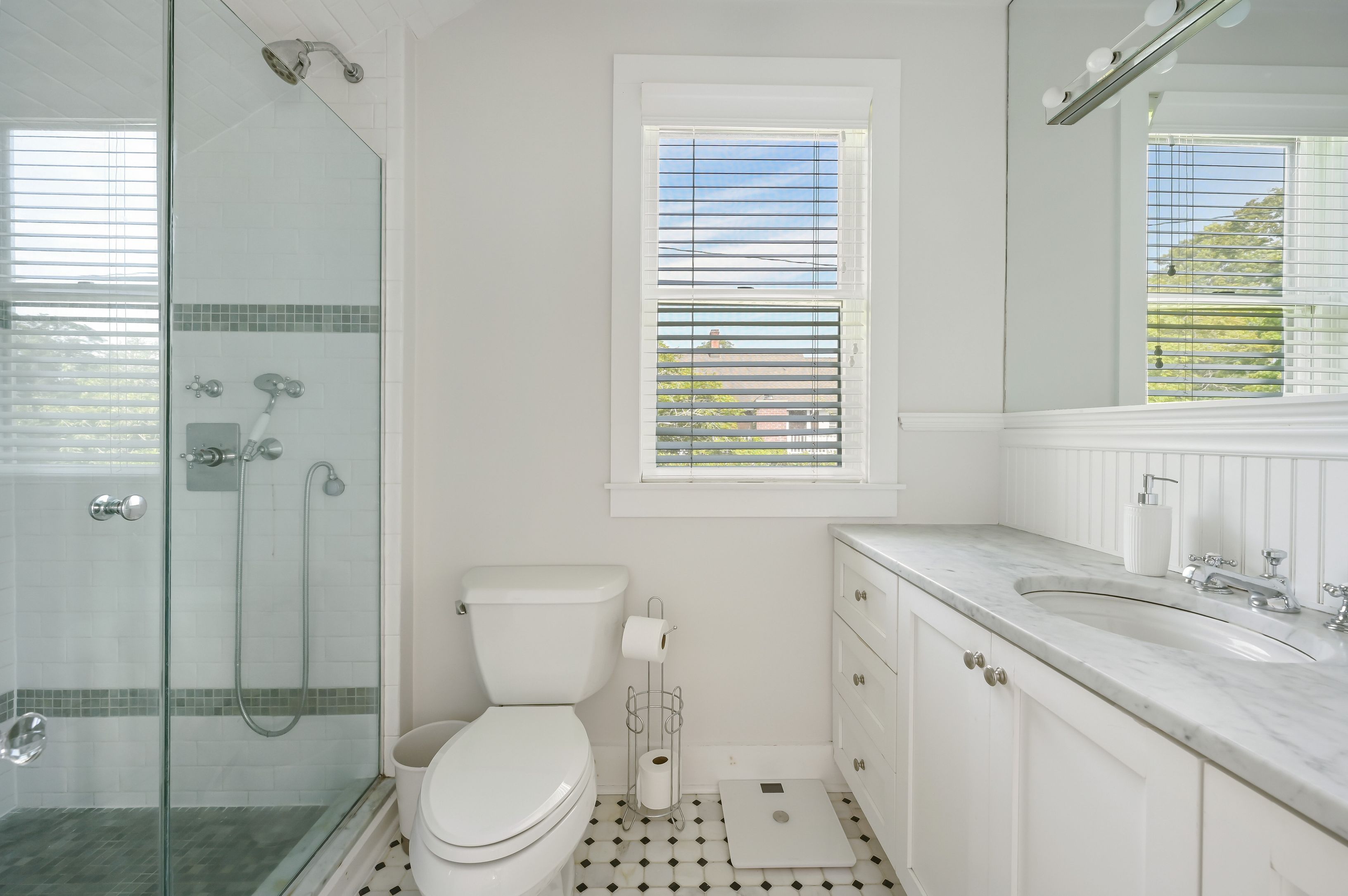 Undisclosed Address Southampton, NY 11968 - Photo 11 of 19 a bathroom with a granite countertop toilet a sink a shower and a mirror