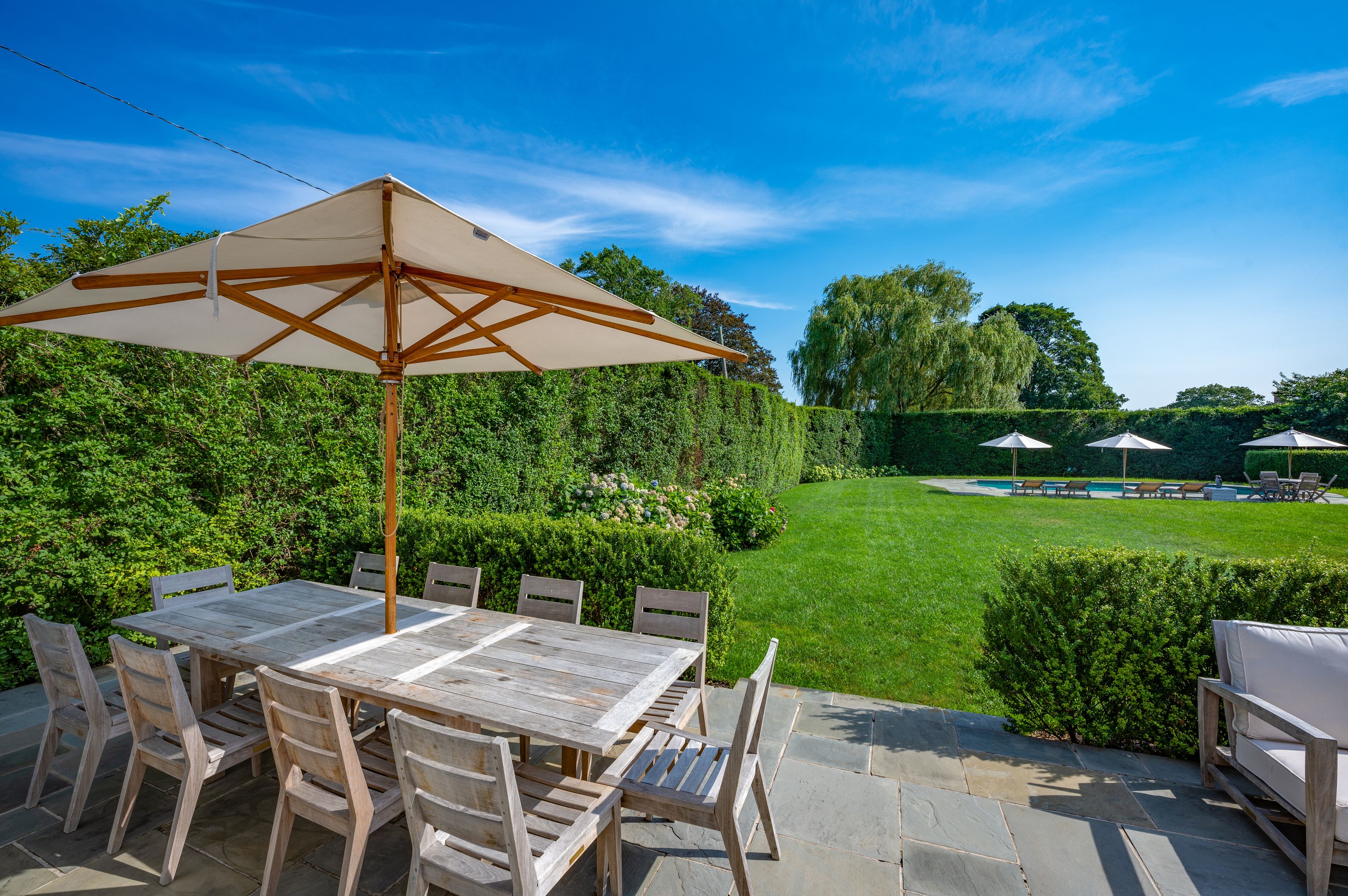 Undisclosed Address Southampton, NY 11968 - Photo 7 of 19 a patio with a yard table and chairs