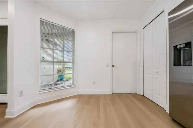 an empty room with windows and closet